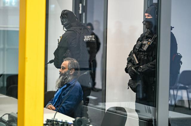 17 November 2025, Saxony-Anhalt, Magdeburg: Defendant Taleb al-Abdulmohsen sits in a bulletproof glass box at Magdeburg District Court during the trial. The public prosecutor's office is accusing the man from Saudi Arabia of 338 counts of attempted murder. On December 20, 2024, Taleb al-Abdulmohsen drove into a crowd of people at Magdeburg's Christmas market, killing 6 and injuring more than 300 people. Photo: Heiko Rebsch/dpa