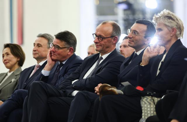 17 November 2025, Hesse, Frankfurt_Main: (L-R) Boris Rhein, Minister President of Hesse, Germany's Chancellor Friedrich Merz, and Mike Josef, Lord Mayor of Frankfurt, sit together as banker Friedrich von Metzler is posthumously awarded the "European Banker" prize. Photo: Hannes P. Albert/dpa