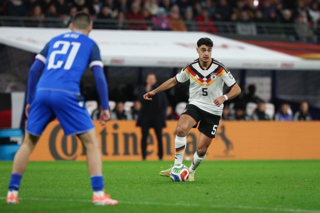 17 November 2025, Saxony, Leipzig: Germany's Aleksandar Pavlovic (R) on the ball in front of Slovakia's Matus Bero during the FIFA World Cup European qualifying soccer match between Germany and Slovakia at Red Bull Arena. Photo: Christian Charisius/dpa