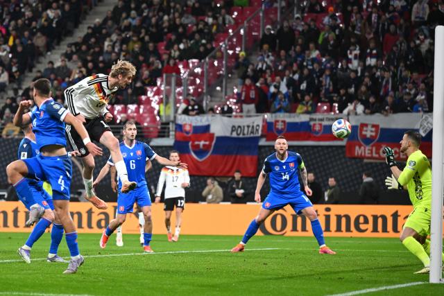 17 November 2025, Saxony, Leipzig: Germany's Nick Woltemade (C) heads in his side's first goal during the FIFA World Cup European qualifying match between Germany and Slovakia at Red Bull Arena. Photo: Robert Michael/dpa