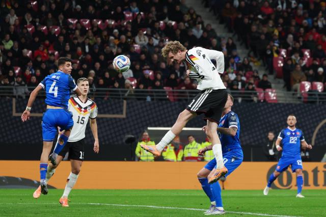 17 November 2025, Saxony, Leipzig: Germany's Nick Woltemade (C) heads in his side's first goal during the FIFA World Cup European qualifying match between Germany and Slovakia at Red Bull Arena. Photo: Christian Charisius/dpa