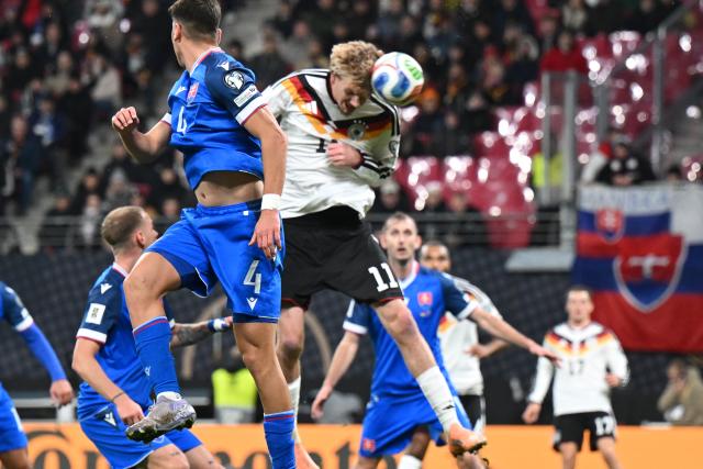 17 November 2025, Saxony, Leipzig: Germany's Nick Woltemade (C) heads in his side's first goal during the FIFA World Cup European qualifying match between Germany and Slovakia at Red Bull Arena. Photo: Robert Michael/dpa