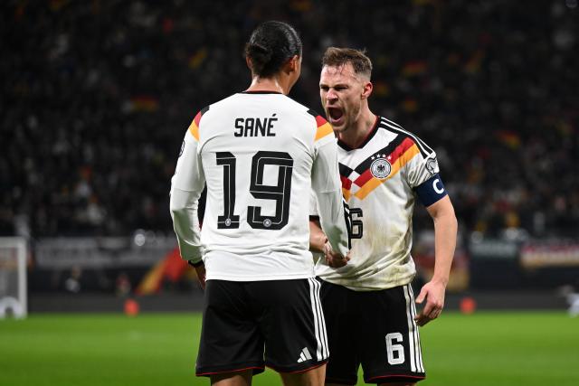 17 November 2025, Saxony, Leipzig: Germany's Leroy Sane celebrates after scoring his side's third goal of the game with teammate Joshua Kimmich during the FIFA World Cup European qualifying match between Germany and Slovakia at Red Bull Arena. Photo: Robert Michael/dpa