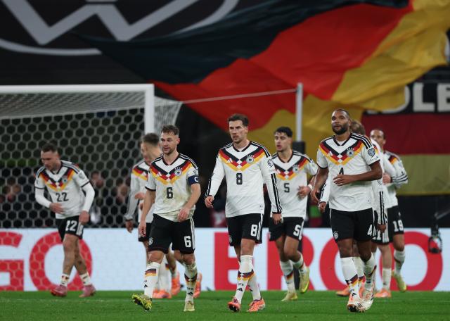 17 November 2025, Saxony, Leipzig: Germany's Joshua Kimmich, Leon Goretzka and Jonathan Tah react on the pitch during the FIFA World Cup European qualifying match between Germany and Slovakia at Red Bull Arena. Photo: Jan Woitas/dpa