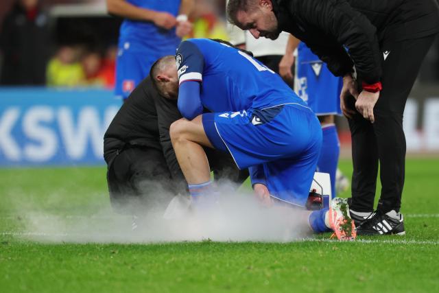 17 November 2025, Saxony, Leipzig: Slovakia's Matus Bero is treated with cold spray during the FIFA World Cup European qualifying match between Germany and Slovakia at Red Bull Arena. Photo: Christian Charisius/dpa
