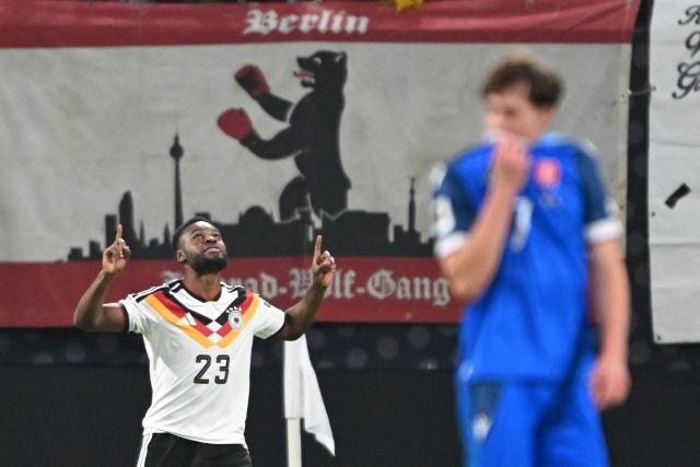 17 November 2025, Saxony, Leipzig: Germany's Ridle Baku (L) celebrates his side's fifth goal of the game during the FIFA World Cup European qualifying match between Germany and Slovakia at Red Bull Arena. Photo: Robert Michael/dpa