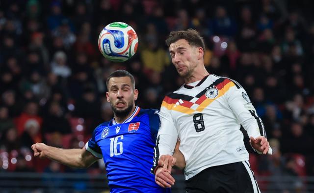 17 November 2025, Saxony, Leipzig: Germany's Leon Goretzka (R) and Slovakia's David Hancko battle for the ball during the FIFA World Cup European qualifying match between Germany and Slovakia at Red Bull Arena. Photo: Jan Woitas/dpa