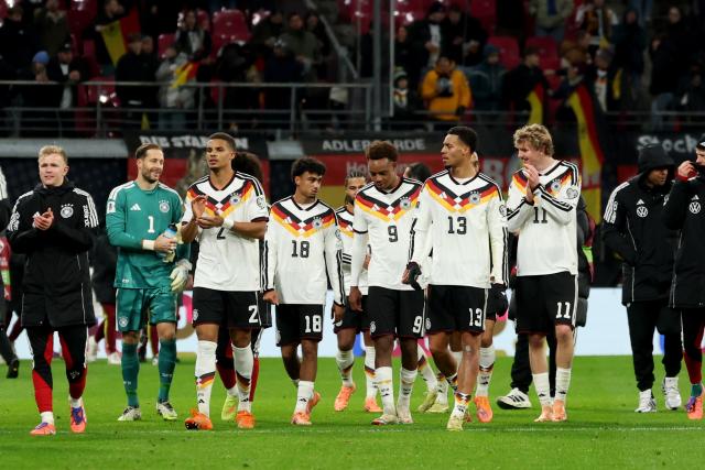 17 November 2025, Saxony, Leipzig: (L-R) Germany's Jonathan Burkardt, goalkeeper Oliver Baumann, Malick Thiaw, Nathaniel Brown, Assan Ouedraogo, Felix Nmecha, Nick Woltemade react after the FIFA World Cup European qualifying match between Germany and Slovakia at Red Bull Arena. Photo: Christian Charisius/dpa
