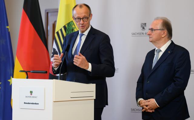 18 November 2025, Saxony-Anhalt, Halle: German Chancellor Friedrich Merz (L) and Minister President of Saxony-Anhalt Reiner Haseloff make a press statement during their visit to the National Academy of Sciences Leopoldina after a cabinet meeting. Photo: Robert Michael/dpa