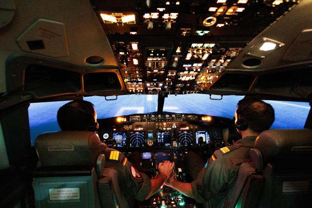 18 November 2025, Berlin: Two pilots sit in the cockpit of the simulator at the start of pilot training for the German Navy's P-8A "Poseidon" by Lufthansa Aviation Training. Photo: Carsten Koall/dpa