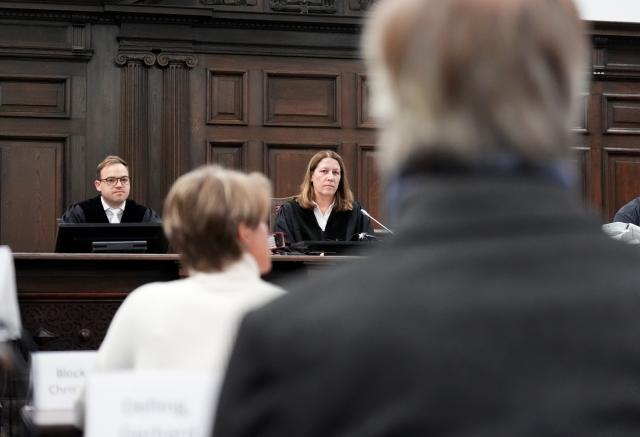 19 November 2025, Hamburg: Chairwoman of the criminal chamber Isabel Hildebrandt (C), German restaurateur and entrepreneur Christina Block and her partner former sports presenter Gerhard Delling (R) sit in a courtroom at the regional court before the start of the trial against C. Block for alleged child abduction. Photo: Marcus Brandt/dpa-Pool/dpa