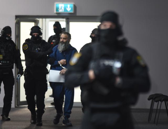 19 November 2025, Saxony-Anhalt, Magdeburg: The defendant Taleb al-Abdulmohsen is led into the courtroom by police officers at Magdeburg District Court, as the public prosecutor's office is accusing hime with 338 counts of attempted murder. On December 20, 2024, the accused drove through the Magdeburg Christmas market. Six people were killed in the attack: five women aged between 45 and 75 and a nine-year-old boy. Photo: Simon Kremer/dpa