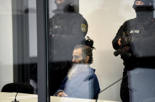 19 November 2025, Saxony-Anhalt, Magdeburg: The defendant Taleb al-Abdulmohsen sits in a bullet-proof glass box in the temporary court building at Magdeburg District Court, as the public prosecutor's office is accusing hime with 338 counts of attempted murder. On December 20, 2024, the accused drove through the Magdeburg Christmas market. Six people were killed in the attack: five women aged between 45 and 75 and a nine-year-old boy. Photo: Simon Kremer/dpa