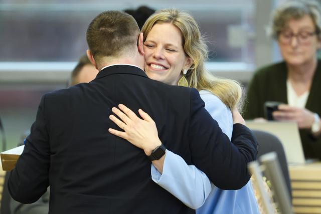 19 November 2025, Schleswig-Holstein, Kiel: Schleswig-Holstein's Minister for Agriculture, Rural Areas, Europe and Consumer Protection Cornelia Schmachtenberg (R) hugs Christian Dirschauer (SSW) after her swearing-in ceremony. Photo: Frank Molter/dpa