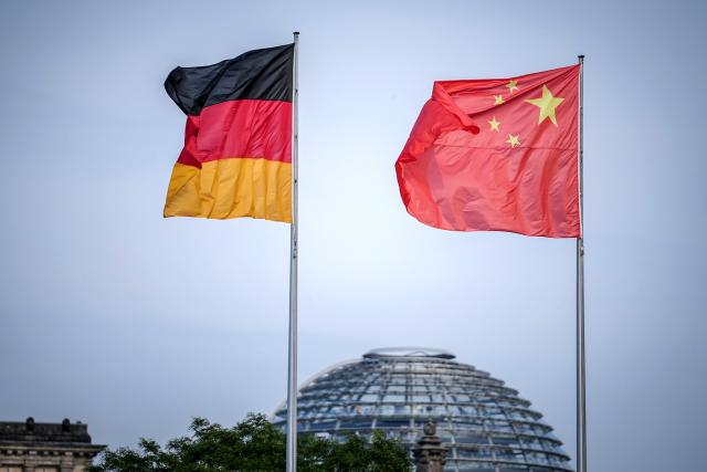 FILED - 19 June 2023, Berlin: The flags of Germany and China wave in the wind in front of the Federal Chancellery. China has again replaced the United States as Germany's top trading partner, with foreign trade turnover nudging up 0.6% on the year to ·185.9 billion ($215.4 billion) from January to September, according to data released on Wednesday. Photo: Kay Nietfeld/dpa