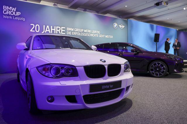 20 November 2025, Saxony, Leipzig: A BMW 1 Series of the 1st generation (l) and one of the current 4th generation stand at the celebrations to mark 20 years of the BMW plant in Leipzig. After the foundation stone was laid in 2002, the first BMW rolled off the production line in Leipzig on March 1, 2005. Today, around 6800 employees produce the 1 Series, the 2 Series Gran Coupe, the 2 Series Active Tourer and the Mini Countryman here. Photo: Jan Woitas/dpa