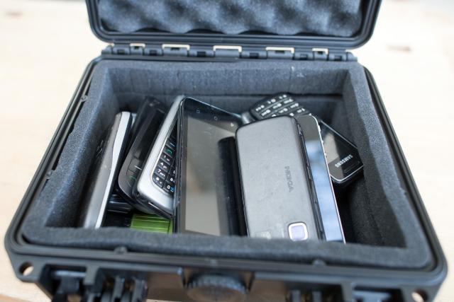 FILED - 21 March 2019, North Rhine-Westphalia, Cologne: A suitcase with mobile phones as odour samples stands on a workbench in a factory building of the Cologne correctional facility.  Authorities in France confiscated 80,000 mobile phones in the country's prisons last year, the justice minister said on Friday. Photo: Federico Gambarini/dpa