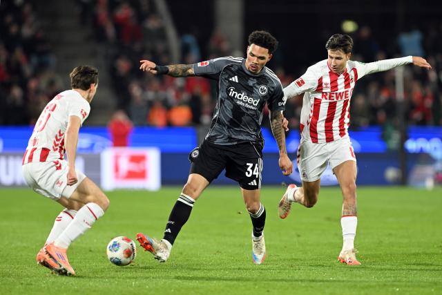 22 November 2025, North Rhine-Westphalia, Cologne: Cologne's Denis Huseinbasic battles for the ball with Eintracht Frankfurt's Nnamdi Collins during the German Bundesliga soccer match between 1. FC Cologne and Eintracht Frankfurt at the RheinEnergieStadion. Photo: Federico Gambarini/dpa - IMPORTANT NOTICE: DFL and DFB regulations prohibit any use of photographs as image sequences and/or quasi-video.