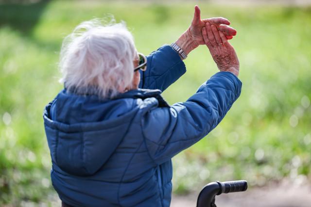FILED - 13 March 2024, Saxony-Anhalt, Köthen: A senior citizen takes part in a rollator yoga course for senior citizens in Koethen Castle Park. The course offers targeted exercises that can be done on and off the rollator. Photo: Jan Woitas/dpa