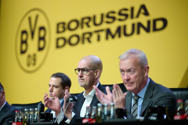24 November 2025, North Rhine-Westphalia, Dortmund: Managing directors Lars Ricken (l-r), Carsten Cramer and Thomas Tress sit on the podium during the Annual General Meeting of Borussia Dortmund GmbH & Co. KGaA on the podium. Photo: Bernd Thissen/dpa