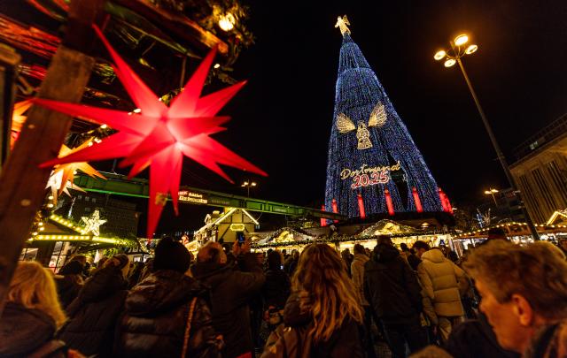 24 November 2025, North Rhine-Westphalia, Dortmund: The giant Christmas tree at the Dortmund Christmas market is lit up with 140,000 thousand LEDs. According to the organizers, the world's largest Christmas tree, which is made up of hundreds of spruce trees and thus reaches a height of 45 meters, will be illuminated with more lights than ever this year. Photo: Dieter Menne/dpa
