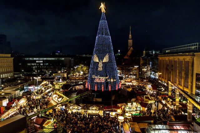 24 November 2025, North Rhine-Westphalia, Dortmund: The giant Christmas tree at the Dortmund Christmas market is lit up with 140,000 thousand LEDs. According to the organizers, the world's largest Christmas tree, which is made up of hundreds of spruce trees and thus reaches a height of 45 meters, will be illuminated with more lights than ever this year. Photo: Dieter Menne/dpa
