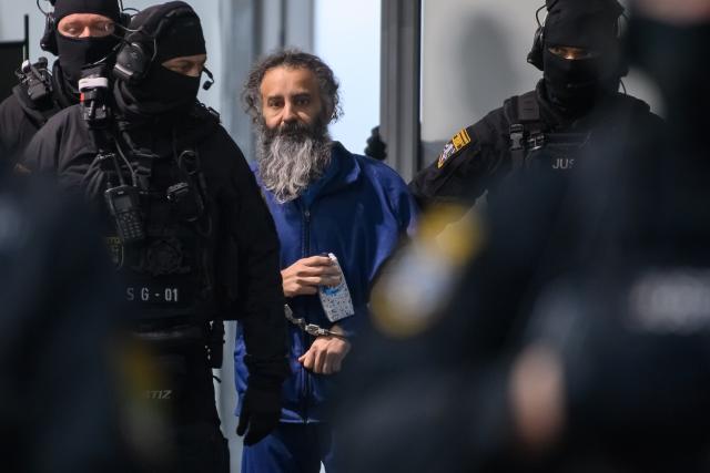 25 November 2025, Saxony-Anhalt, Magdeburg: Judicial officers lead the defendant Taleb al-Abdulmohsen (L) into the courtroom of the temporary court building at Magdeburg District Court. The public prosecutor's office is accusing the man from Saudi Arabia of 338 counts of attempted murder. On December 20, 2024, Taleb al-Abdulmohsen drove into a crowd of people at Magdeburg's Christmas market, killing 6 and injuring more than 300 people. Photo: Klaus-Dietmar Gabbert/dpa