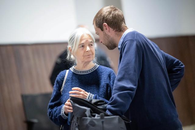 25 November 2025, Lower Saxony, Verden: Defendant Daniela Klette stands with her lawyer Lukas Theune at the beginning of the trial day in the provisional courtroom of the Verden district court in Verden-Eitze. The former RAF terrorist has been on trial since the end of March for a series of attacks on supermarkets and cash-in-transit vehicles between 1999 and 2016. Photo: Sina Schuldt/dpa
