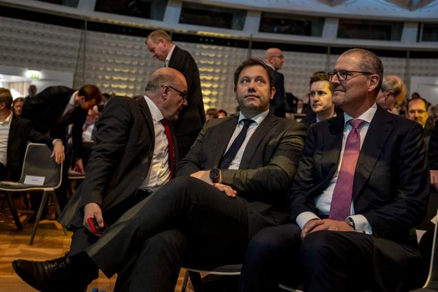 25 November 2025, Berlin: Lars Klingbeil (C), German Minister of Finance, sits next to Rainer Dulger (R), Employers' President, in front of the stage at the Employers' Day 2025. Photo: Fabian Sommer/dpa