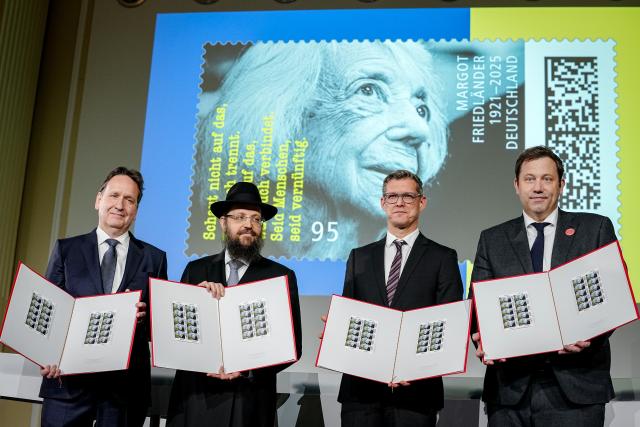 25 November 2025, Berlin: (L-R) Karsten Dreinhoefer from the Margot Friedländer Foundation, Rabbi Yehuda Teichtal, Benjamin Rasch, Deutsche Post, and German Minister of Finance Lars Klingbeil present the special postage stamp in honor of Holocaust survivor Margot Friedlaender at the Federal Ministry of Finance. Friedlaender lived from 1921-2025. Photo: Kay Nietfeld/dpa