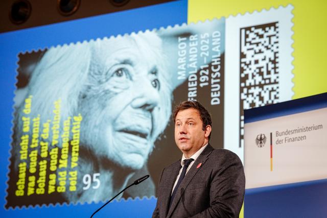 25 November 2025, Berlin: German Minister of Finance Lars Klingbeil presents the special postage stamp in honor of Holocaust survivor Margot Friedlaender at the Federal Ministry of Finance. Friedlaender lived from 1921-2025. Photo: Kay Nietfeld/dpa