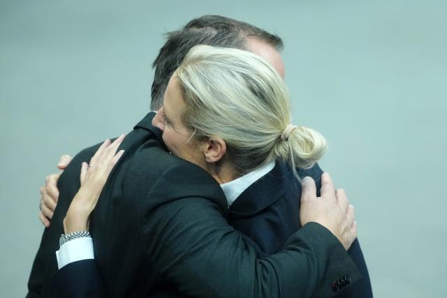 26 November 2025, Berlin: Alice Weidel, parliamentary group and federal leader of the AfD, hugs Tino Chrupalla, AfD federal and parliamentary group leader, after his speech in the general debate on the budget in the Bundestag. The debates on the budget of the Chancellery are traditionally used as a general debate on the policies of the Federal Government. Photo: Kay Nietfeld/dpa