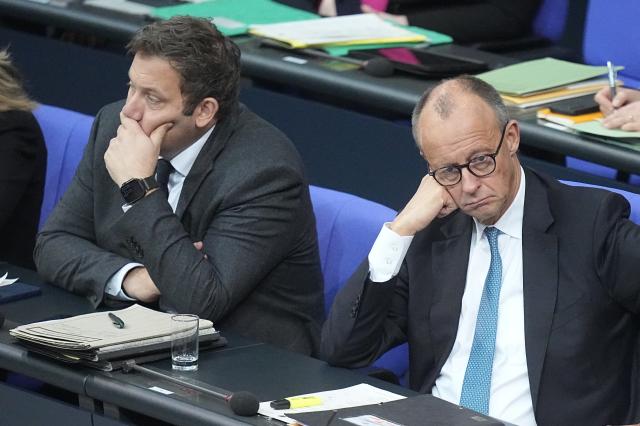 26 November 2025, Berlin: German Finance Minister Lars Klingbeil (L) and German Chancellor Friedrich Merz sit on the government bench during the general debate in the Bundestag. The debates on the budget of the Chancellor's Office are traditionally used as a general debate on the policies of the Federal Government. Photo: Michael Kappeler/dpa