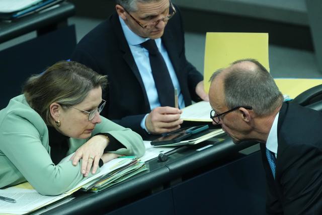 26 November 2025, Berlin: Stefanie Hubig (L), German Minister of Justice and Consumer Protection, and German Chancellor Friedrich Merz (R) talk on the government bench during the general debate in the Bundestag on the budget, with Thorsten Frei, Head of the Federal Chancellery and Federal Minister for Special Tasks, sitting between them. The debates on the budget of the Chancellery are traditionally used as a general debate on the policies of the Federal Government. Photo: Michael Kappeler/dpa