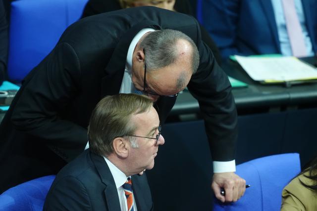 26 November 2025, Berlin: German Chancellor Friedrich Merz talks to Defense Minister Boris Pistorius on the government bench during the general debate in the Bundestag on the budget. The debates on the budget of the Chancellor's Office are traditionally used as a general debate on the policies of the Federal Government. Photo: Kay Nietfeld/dpa