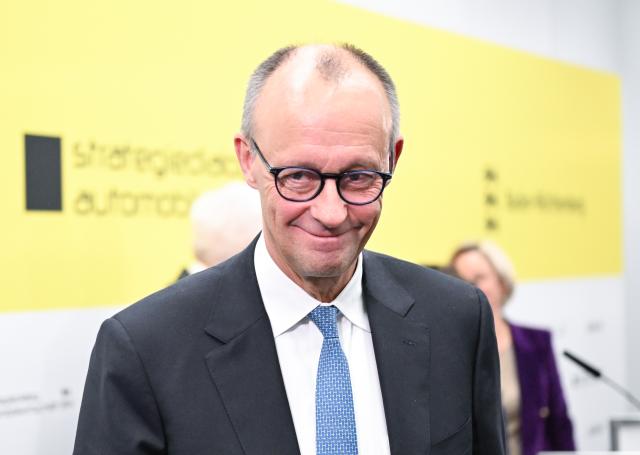 26 November 2025, Baden-Württemberg, Stuttgart: German Chancellor Friedrich Merz leaves the press conference room after the Strategy Dialogue for the Automotive Industry. Photo: Bernd Weißbrod/dpa