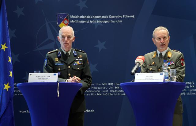 27 November 2025, Baden-Württemberg, Ulm: Dutch Lieutenant General Michiel van der Laan (L), the highest military representative of the EU and Director General of the EU Military Staff, and Austrian Major General Reinhard Trischak, Deputy Commander of the Multinational Operational Command, speak during a meeting of the military commanders of the European Union in the Wilhelmsburg barracks. Photo: Karl-Josef Hildenbrand/dpa