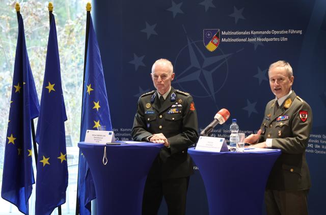 27 November 2025, Baden-Württemberg, Ulm: Dutch Lieutenant General Michiel van der Laan (L), the highest military representative of the EU and Director General of the EU Military Staff, and Austrian Major General Reinhard Trischak, Deputy Commander of the Multinational Operational Command, speak during a meeting of the military commanders of the European Union in the Wilhelmsburg barracks. Photo: Karl-Josef Hildenbrand/dpa
