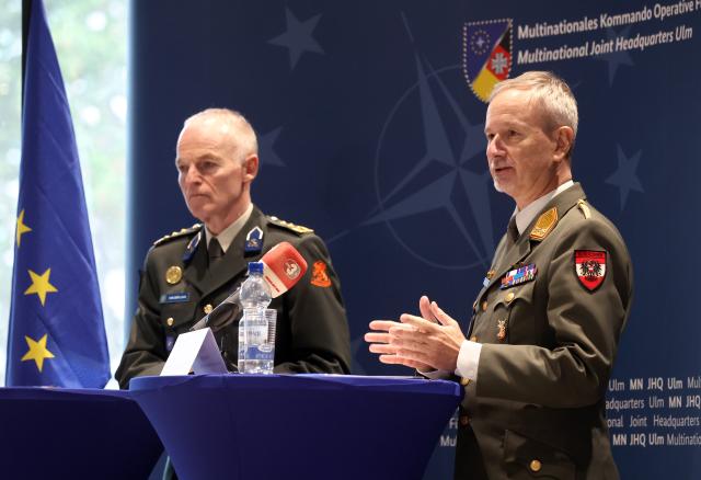 27 November 2025, Baden-Württemberg, Ulm: Dutch Lieutenant General Michiel van der Laan (L), the highest military representative of the EU and Director General of the EU Military Staff, and Austrian Major General Reinhard Trischak, Deputy Commander of the Multinational Operational Command, speak during a meeting of the military commanders of the European Union in the Wilhelmsburg barracks. Photo: Karl-Josef Hildenbrand/dpa
