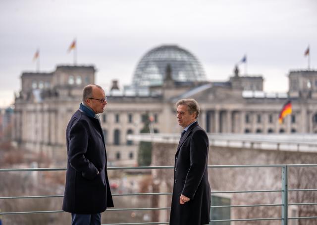 28 November 2025, Berlin: Federal Chancellor Friedrich Merz (L) stands next to Robert Golob, Prime Minister of Slovenia, on the balcony of the Federal Chancellery. The talks will focus on bilateral relations, joint support for Ukraine, the Western Balkans and European policy issues. Photo: Michael Kappeler/dpa