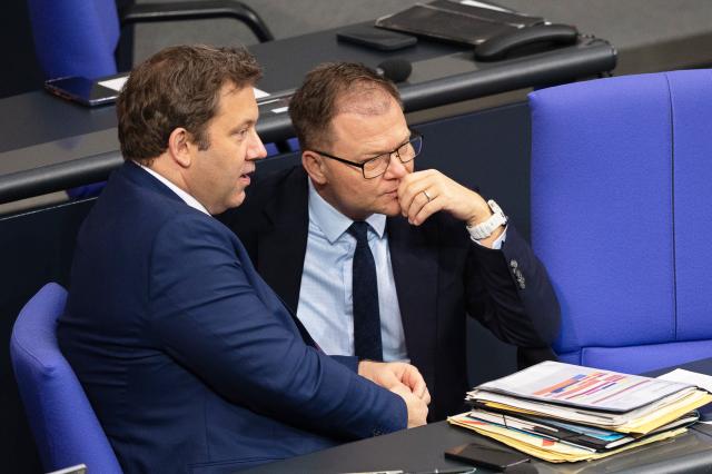 28 November 2025, Berlin: Lars Klingbeil (L), German Minister of Finance, speaks with Carsten Schneider, German Minister for the Environment, Climate Protection, Nature Conservation and Nuclear Safety, during the debate on the federal budget in the Bundestag. Photo: Markus Lenhardt/dpa