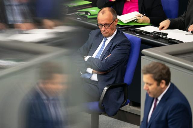 28 November 2025, Berlin: German Chancellor Friedrich Merz follows the speech by Lars Klingbeil (front, SPD), german Minister of Finance, in the debate on the federal budget in the Bundestag. Photo: Markus Lenhardt/dpa