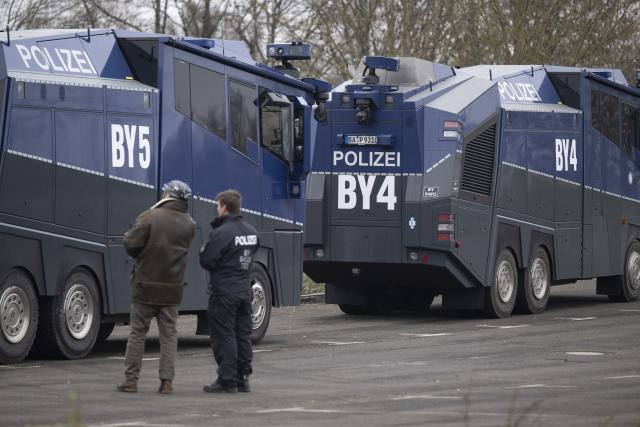 28 November 2025, Hesse, Giessen: Police water cannons stand ready near the Giessen exhibition center, where thousands of counter-demonstrators are expected to attend the planned re-founding of the Alternative for Germany (AfD) youth organization on Saturday. Photo: Boris Roessler/dpa