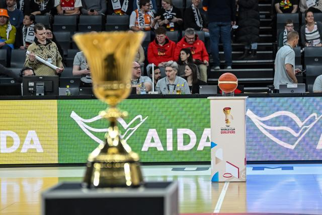 28 November 2025, Bavaria, Neu-Ulm: The World Cup trophy (Front) and the match ball are on pedestals in the ratiopharm arena ahead of the World Cup European qualifier Basketball match between Germany and Israel. Photo: Harry Langer/dpa
