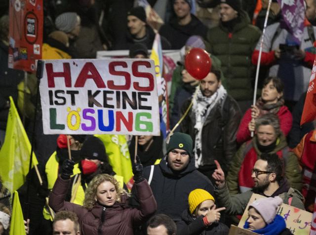 28 November 2025, Hesse, Gießen: Participants from various organizations protest in Giessen against the founding meeting of the new AfD youth organization. One participant carries a sign reading "Hate is not a solution". The demonstration is accompanied by a massive police presence. Photo: Boris Roessler/dpa