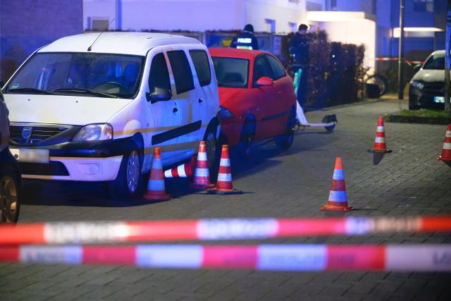 29 November 2025, North Rhine-Westphalia, Cologne: Police markings and fluttering tape can be seen on Butzweilerhofallee in Cologne-Ossendorf. Two men have been shot during an altercation in Cologne. Photo: Henning Kaiser/dpa - ATTENTION: Markings have been made unrecognizable.