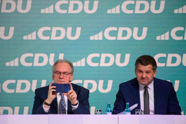 29 November 2025, Saxony-Anhalt, Magdeburg: Reiner Haseloff (l), Minister President of Saxony-Anhalt, and Sven Schulze, Chairman of the Saxony-Anhalt CDU and the CDU's runner-up candidate in the 2026 state elections, sit next to each other on the podium at the CDU's state party conference. The delegates want to elect a new state executive committee at the party conference. Photo: Klaus-Dietmar Gabbert/dpa