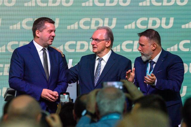29 November 2025, Saxony-Anhalt, Magdeburg: Reiner Haseloff (C), Minister President of Saxony-Anhalt, and Mario Karschunke (R), Secretary General of the Saxony-Anhalt CDU, applaud and congratulate Sven Schulze (L), Chairman of the Saxony-Anhalt CDU and CDU candidate for the 2026 state parliamentary elections, after his speech at the Saxony-Anhalt CDU state party conference. The delegates want to elect a new state executive at the party conference. Photo: Klaus-Dietmar Gabbert/dpa