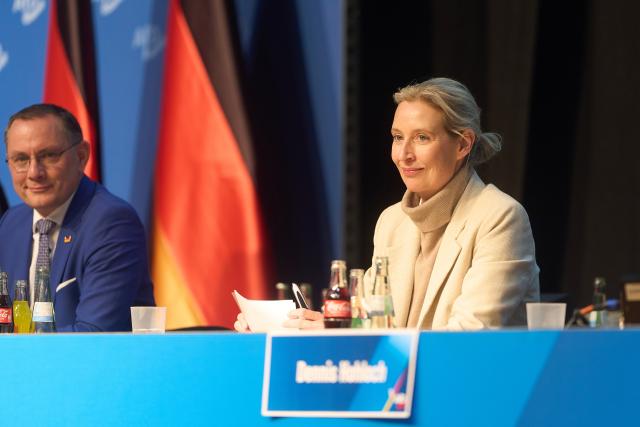 29 November 2025, Hesse, Gießen: Tino Chrupalla (l-r, AfD), co-chair of the AfD parliamentary group, and Alice Weidel (AfD), co-chair of the AfD parliamentary group, sit on the podium at the founding event of the AfD youth organization. Its predecessor "Junge Alternative", which was classified as right-wing extremist, had dissolved itself. The two federal co-chairs are also due to speak at the founding event in the Hessenhallen. Photo: Thomas Frey/dpa