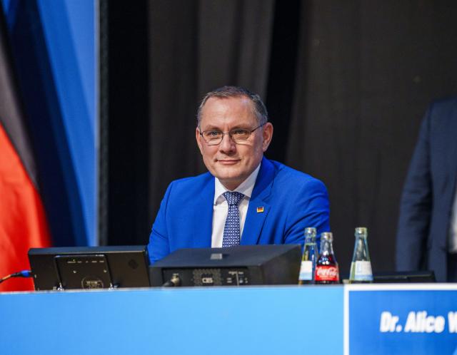 29 November 2025, Hesse, Giessen: Tino Chrupalla (AfD), co-chair of the AfD parliamentary group, sits on the podium at the founding event of the AfD youth organization. Its predecessor "Junge Alternative", which was classified as right-wing extremist, had dissolved itself. The two federal co-chairs are also due to speak at the founding event in the Hessenhallen. Photo: Andreas Arnold/dpa